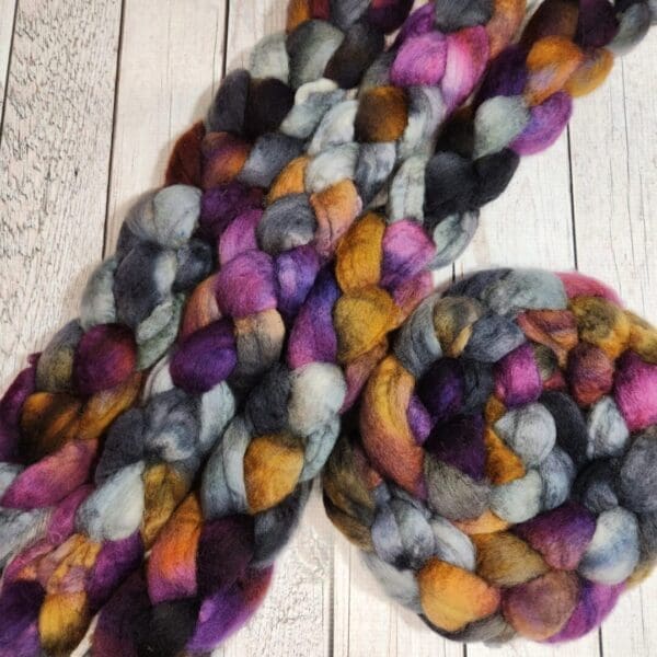 A skein of Disco Date ~ 100g Hand-Dyed Luxury Combed Top Fiber and a skein of Disco Date ~ 100g Hand-Dyed Luxury Combed Top Fiber.